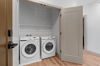 a washer and dryer in a laundry room with a closet